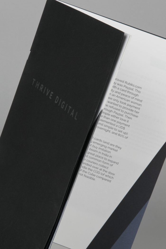 A black folder with a piece of paper inside of it.