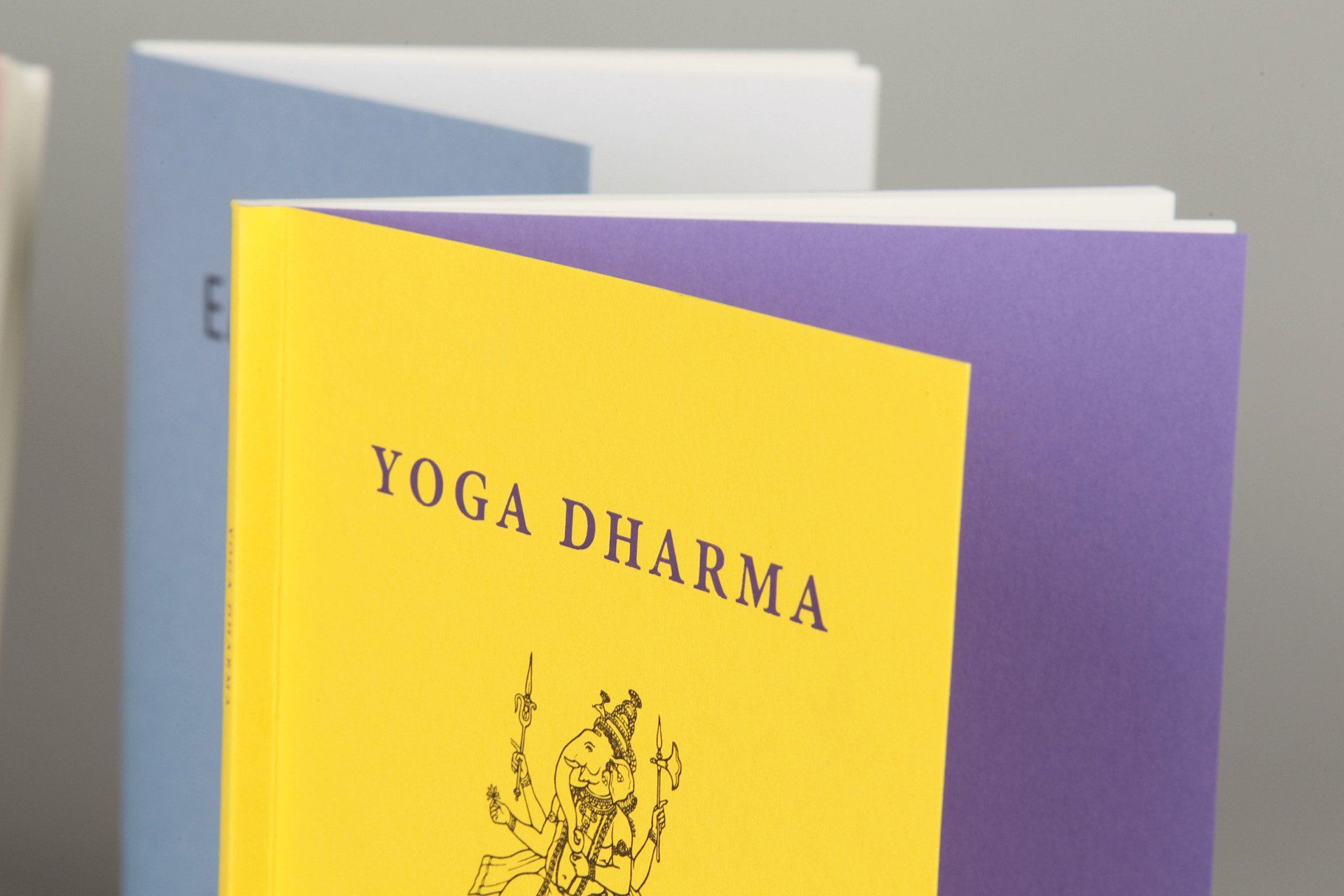 A yellow and purple book titled yoga dharma