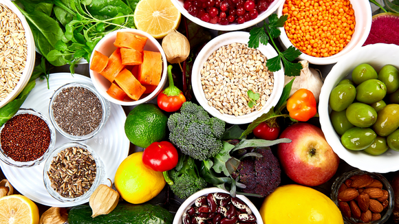 Variety of colorful fruits and vegetables in bowls, promoting healthy eating.
