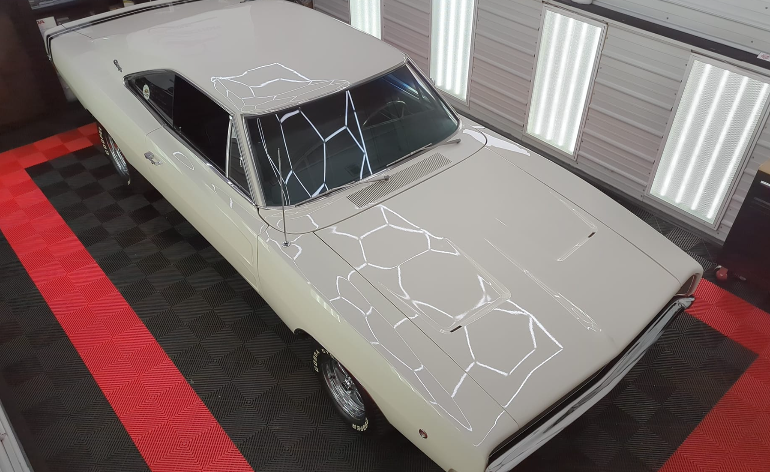 White Corvette sports car parked in a garage.