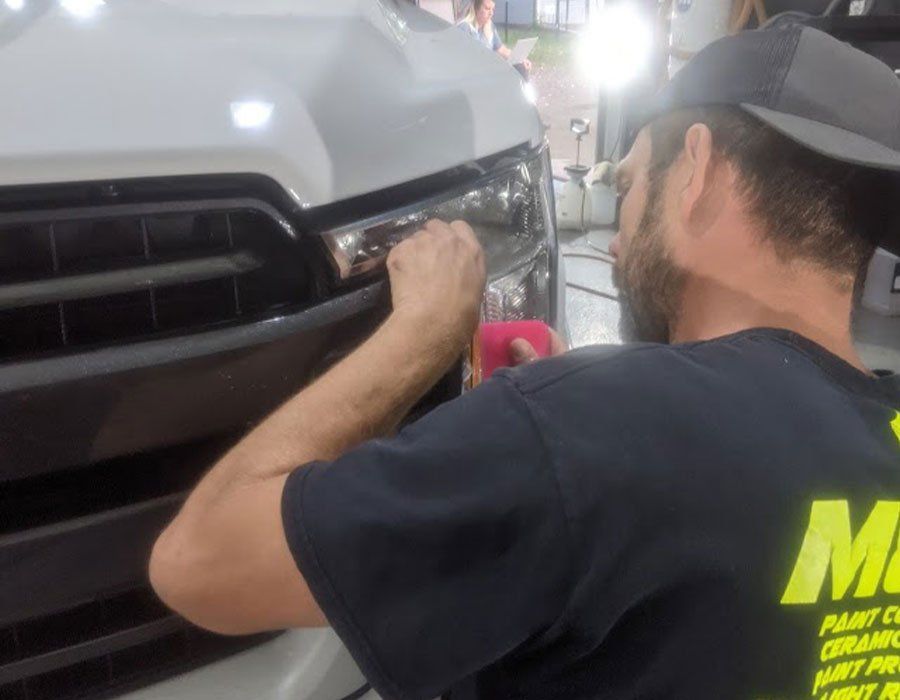 A man wearing a black shirt with the letter m on it