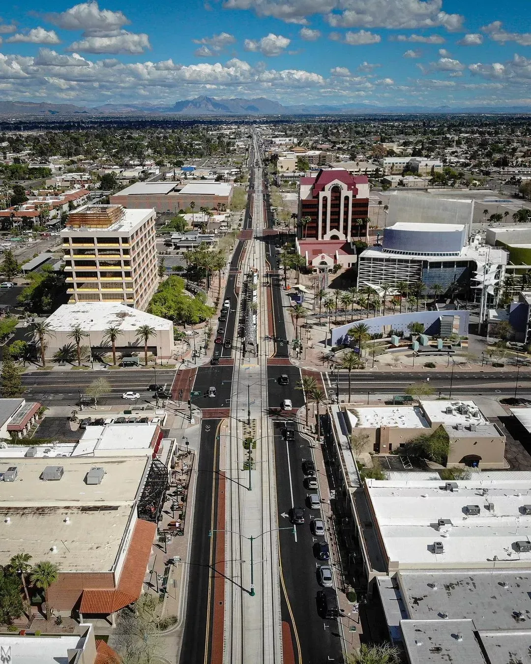 An aerial view of a city with a train track going through it.