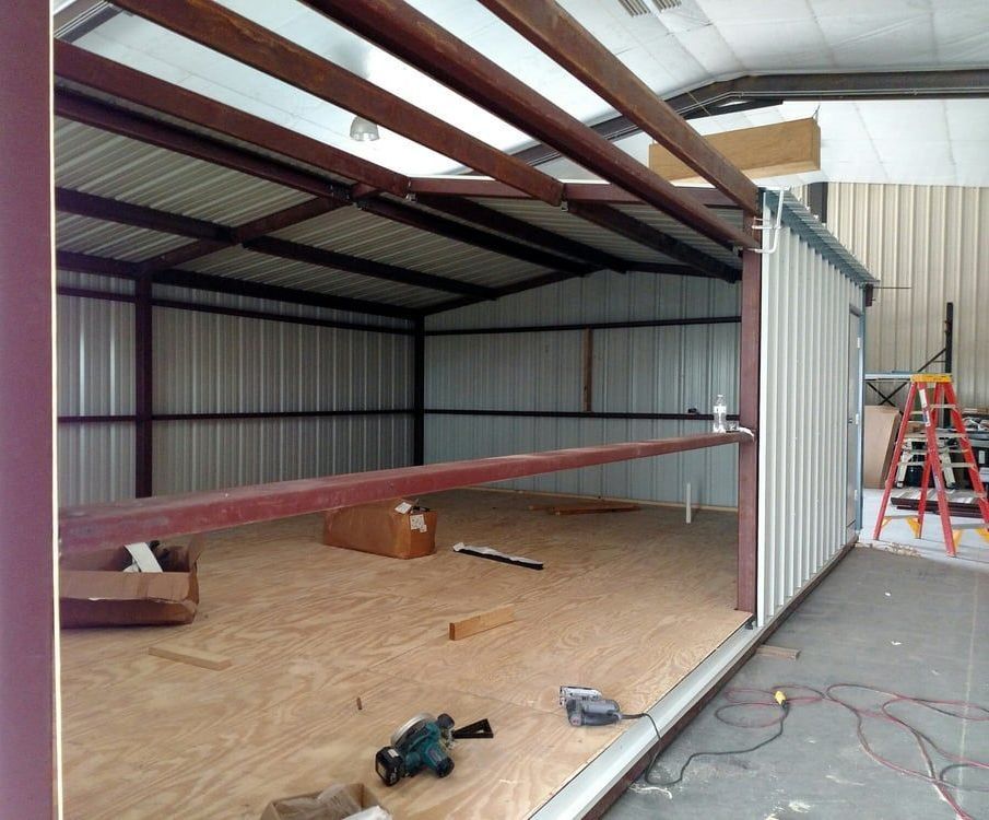 A large metal building with a white garage door