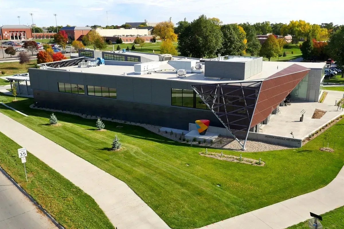 An aerial view of the Jackson Dinsdale Art Center, surrounded by grass and trees.