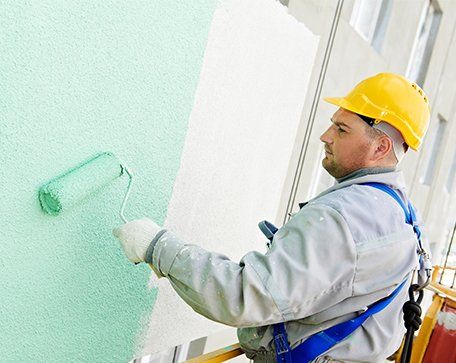 Exterior Painting — Painter Working on the Building Exterior in Central Florida