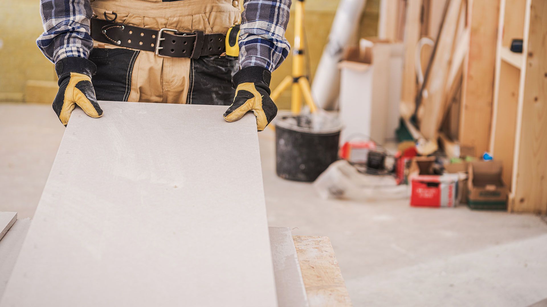 A man is holding a piece of concrete in his hands.