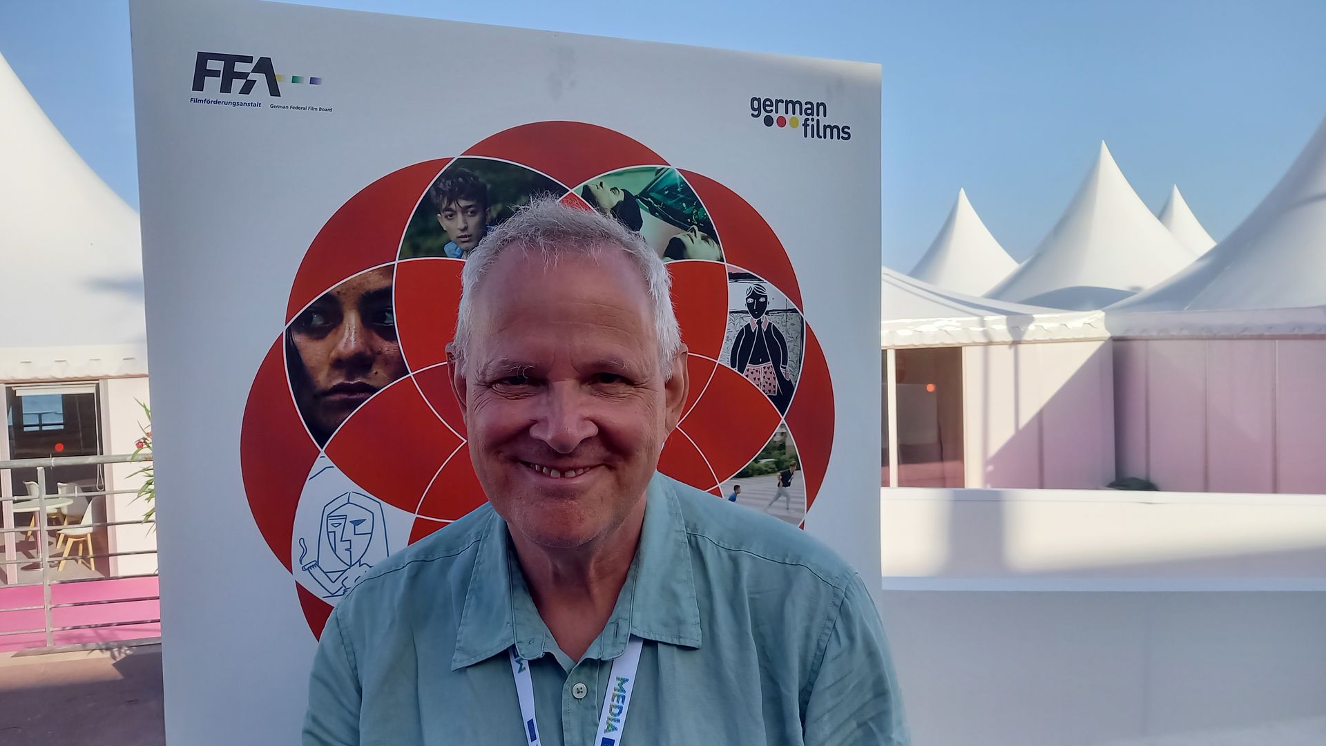 Thom Palmen in front of German Short Film poster Cannes Film Festival 2023