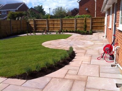 indian stone patio and turfed lawn area