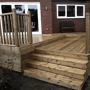 decking, wooden steps and balustrade with bi-fold patio doors visible