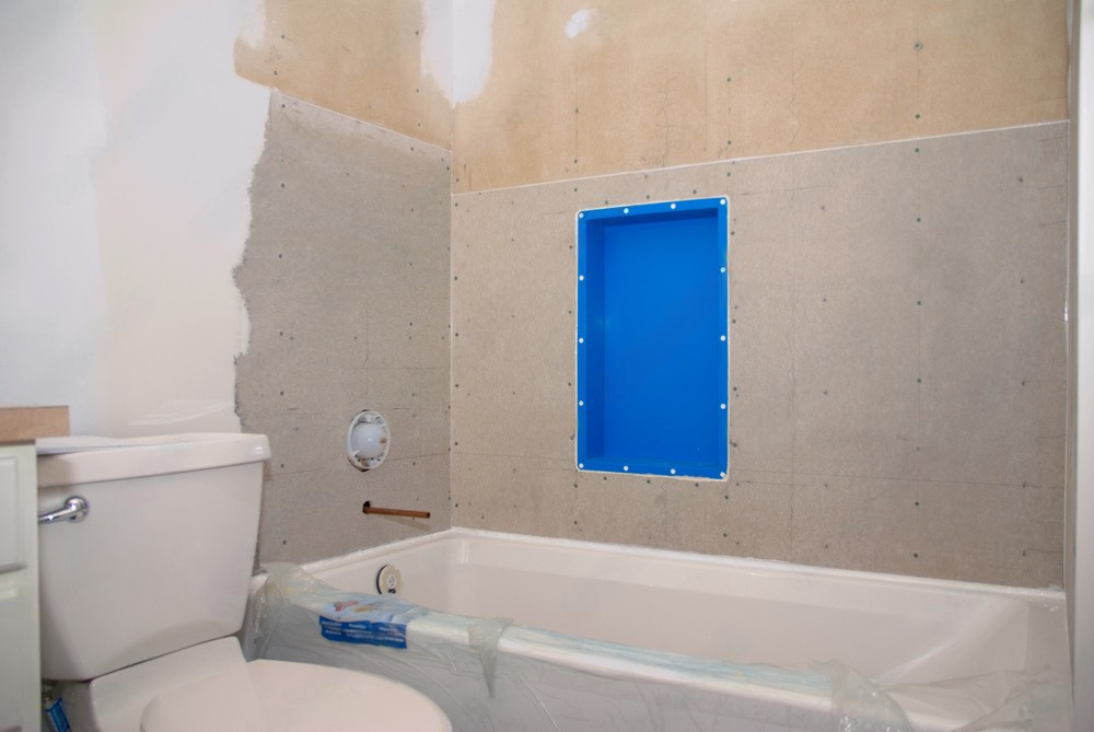 a bathroom under construction with a toilet , bathtub and shower .