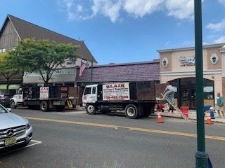Residential Carting & Demolition Services — Dump Truck Outside Property in Middletown, NJ