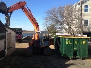 Dumpster Containers — Excavator Beside Dumpster in Middletown, NJ