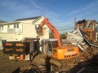 Cleanout Services — Excavator Removing Junk in Middletown, NJ