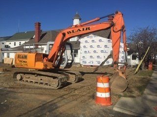 Residential Demolition — Excavator Picking Up Junk in Middletown, NJ