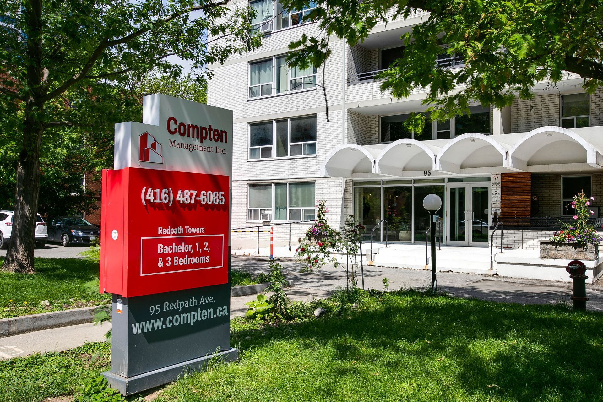 A large building with a complex sign in front of it