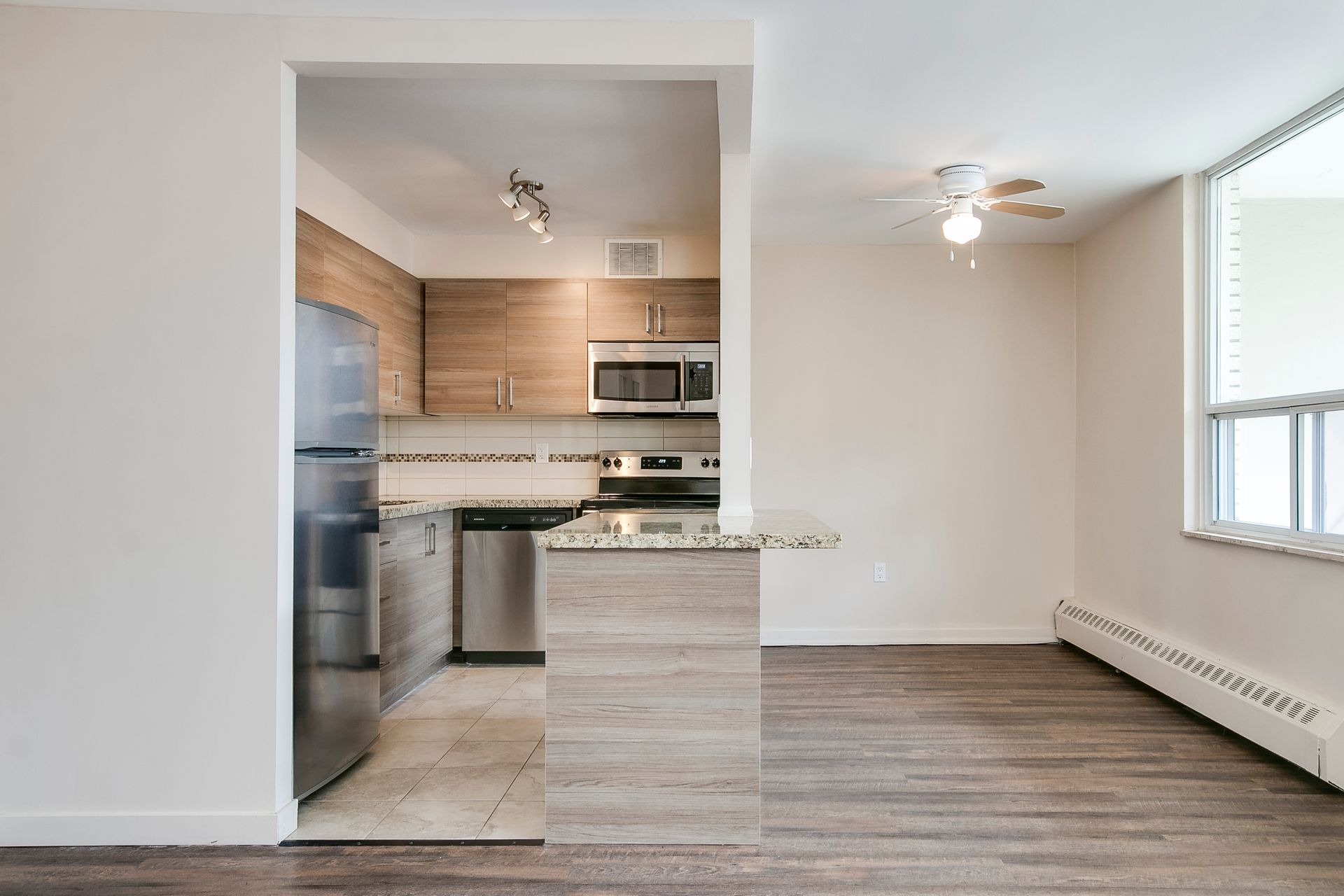 A kitchen with stainless steel appliances and wooden cabinets
