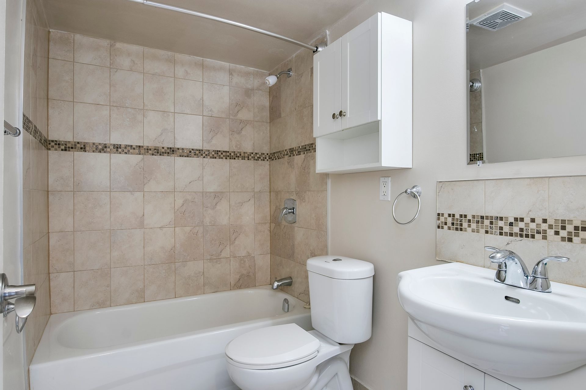 A bathroom with a toilet , sink and bathtub
