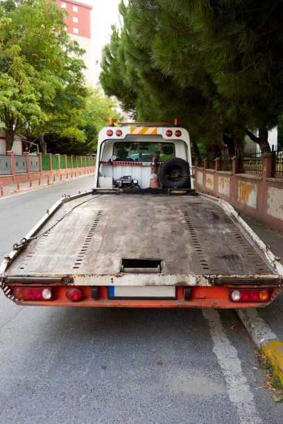 A tow truck is parked on the side of the road.