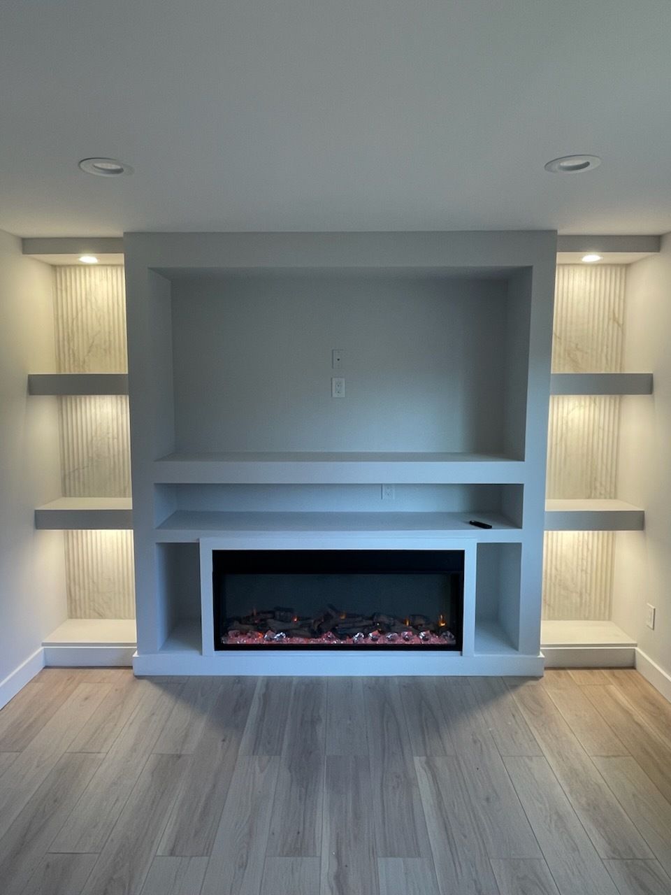 Solar panel installation: Person using drill, laptop, test equipment, hard hat, and baseball cap on panels.