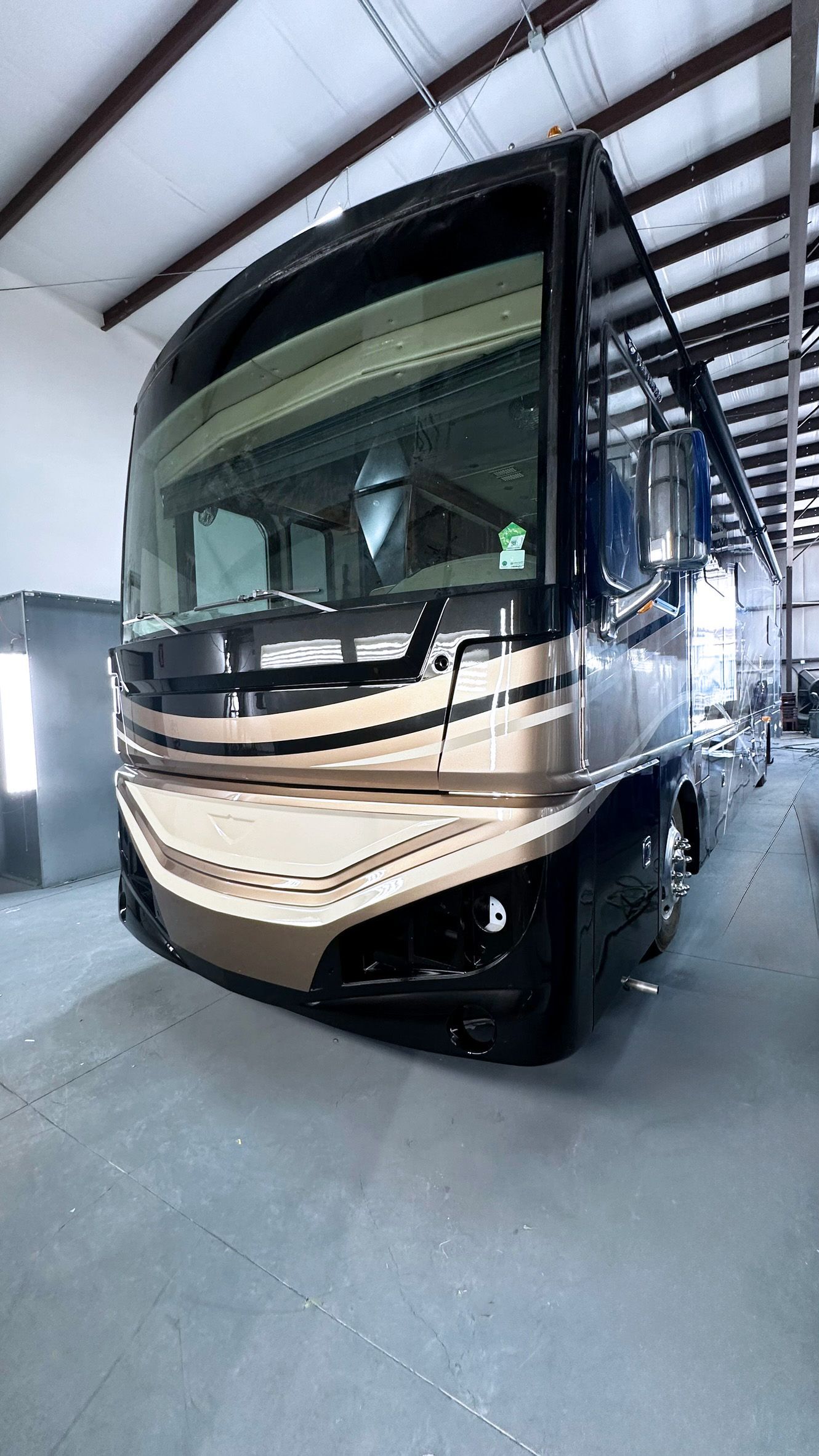 A large rv is parked in a garage.