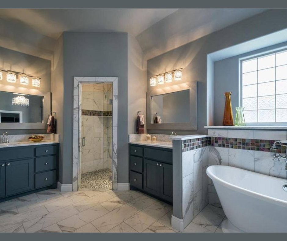A bathroom with two sinks , a tub and a shower.