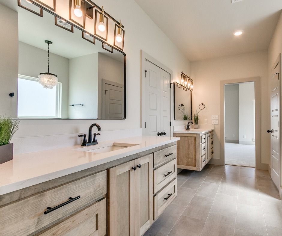 a bathroom with two sinks and a large mirror