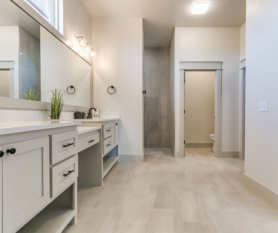 a bathroom with two sinks , a toilet , and a walk in shower