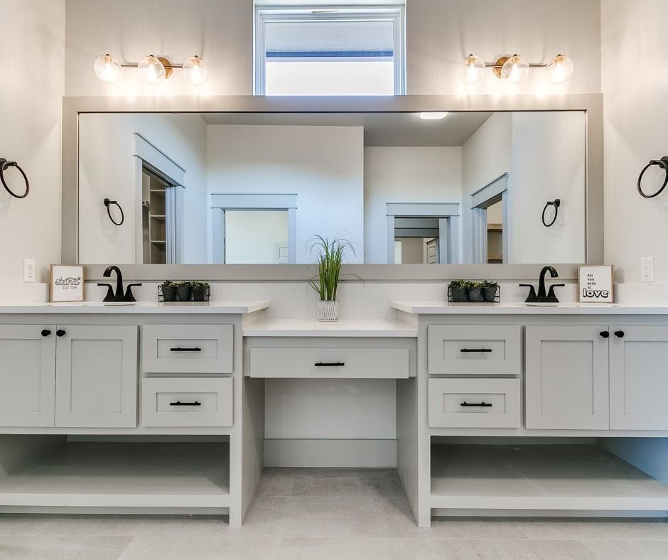 a bathroom with two sinks and a large mirror