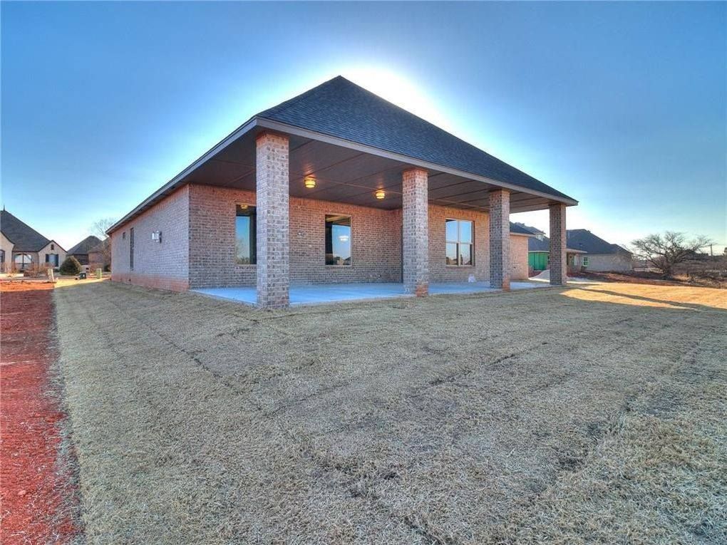 A brick house with a covered porch and columns