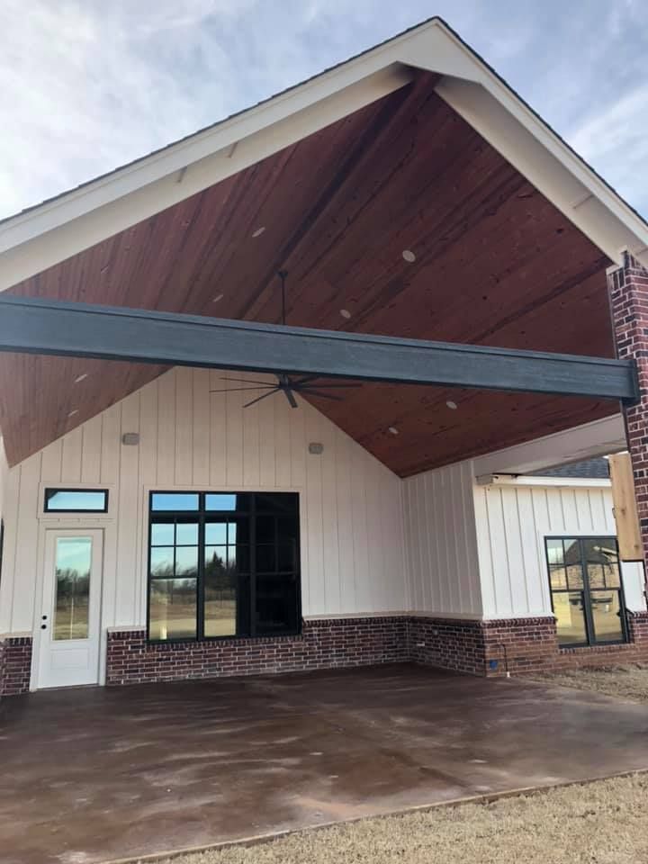 A white house with a wooden ceiling and a brick wall