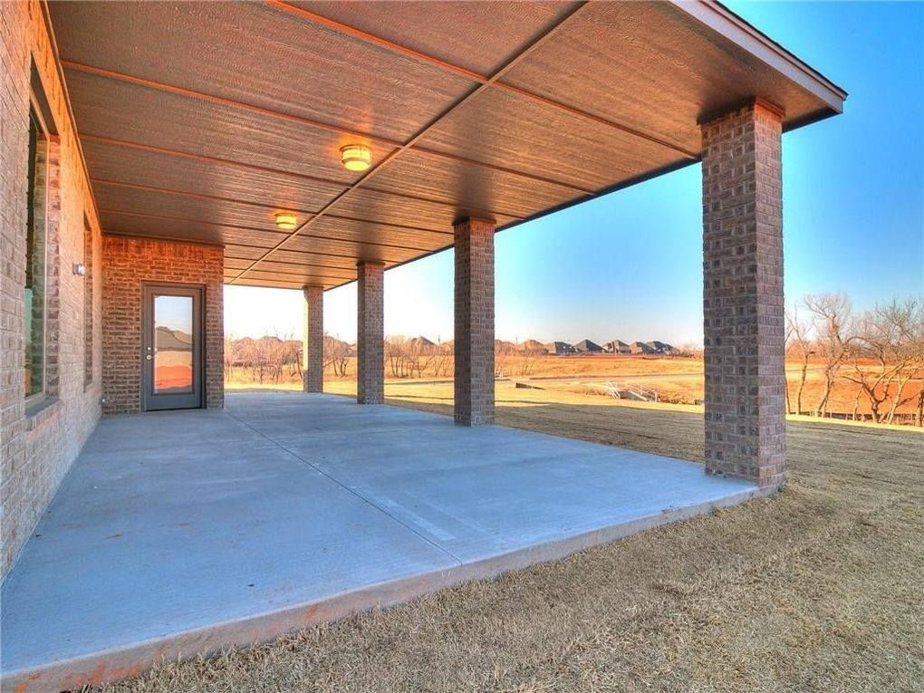A large covered patio with columns and a door