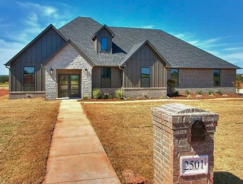 A large house with a brick mailbox in front of it