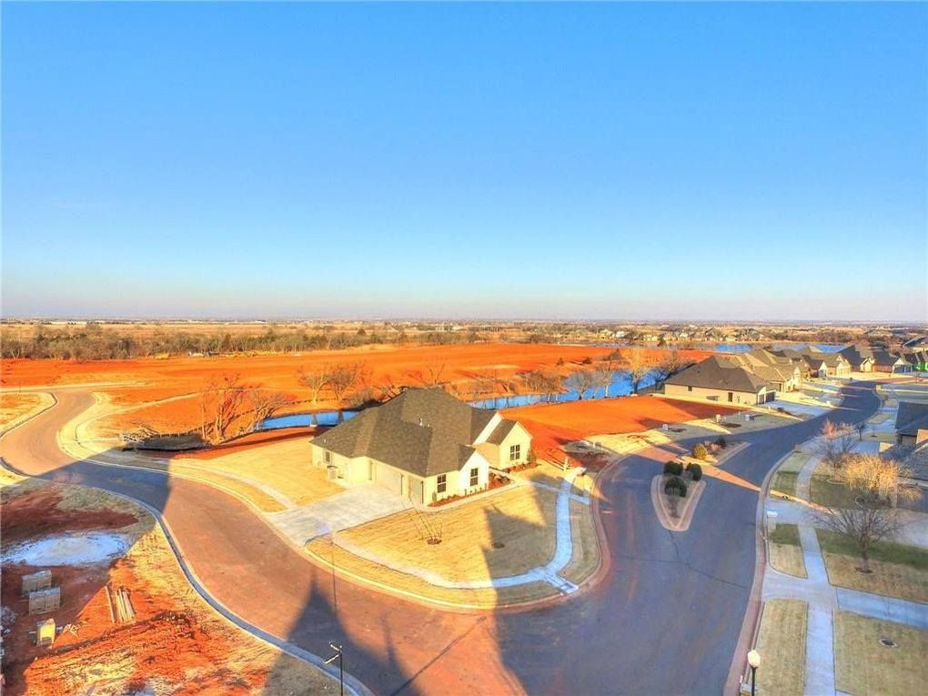 An aerial view of a residential area with a house in the middle.