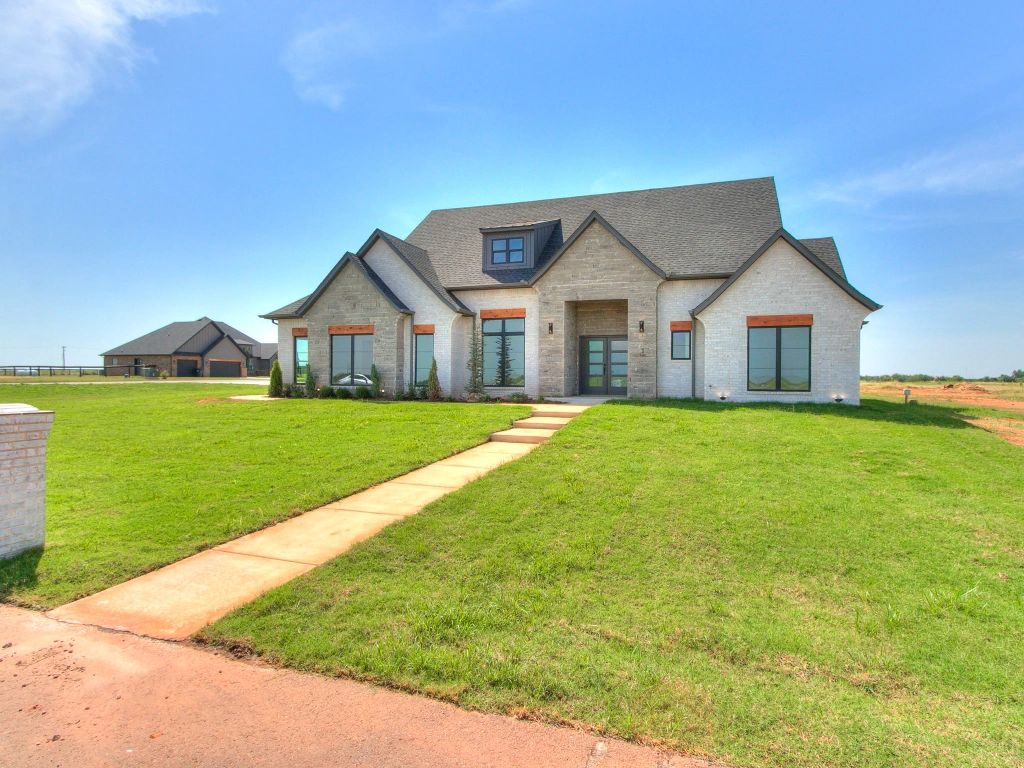 A large white house with a walkway leading to it