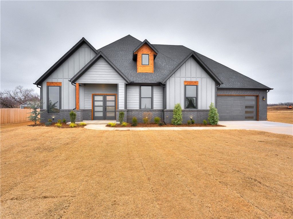 A large house with a gray roof and orange trim