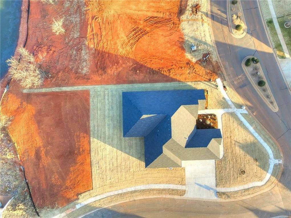 An aerial view of a house with a blue roof