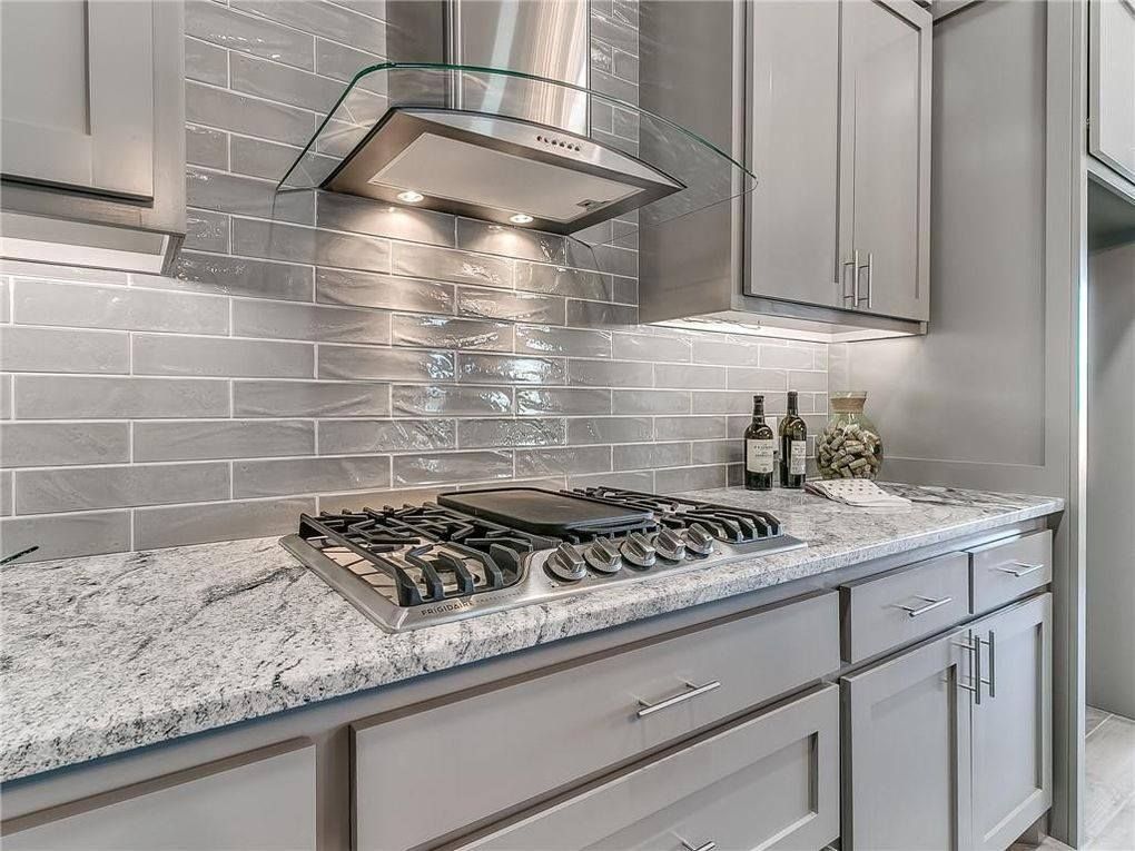 A kitchen with a stove top oven , granite counter tops , and stainless steel appliances.