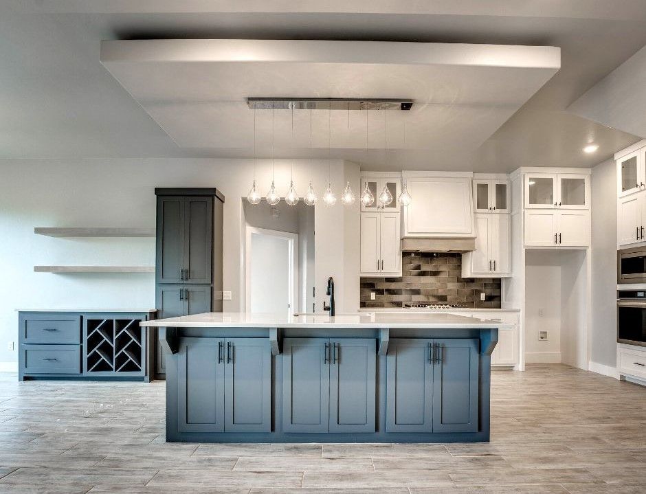 A kitchen with blue cabinets and a large island