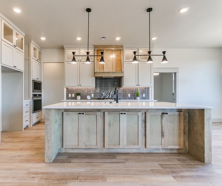 There is a large island in the middle of the kitchen.