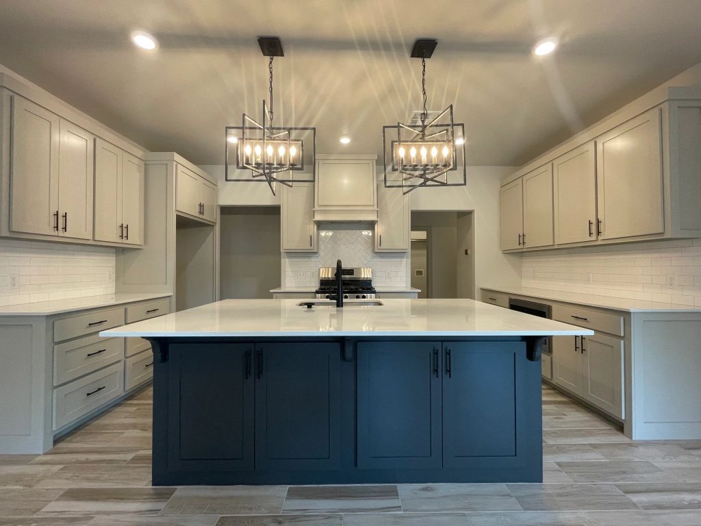 There is a large island in the middle of the kitchen.