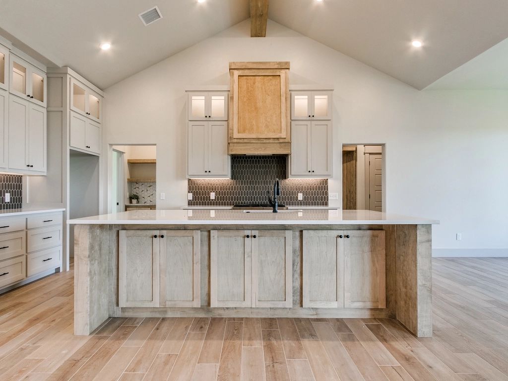 A kitchen with a large island in the middle of the room.