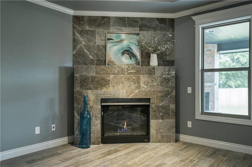 There is a fireplace in the corner of the room.