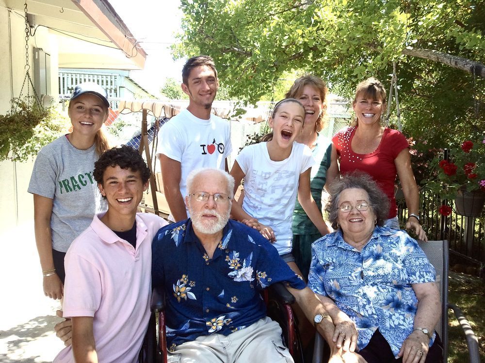 A group of people posing for a picture with one wearing a shirt that says i love peace