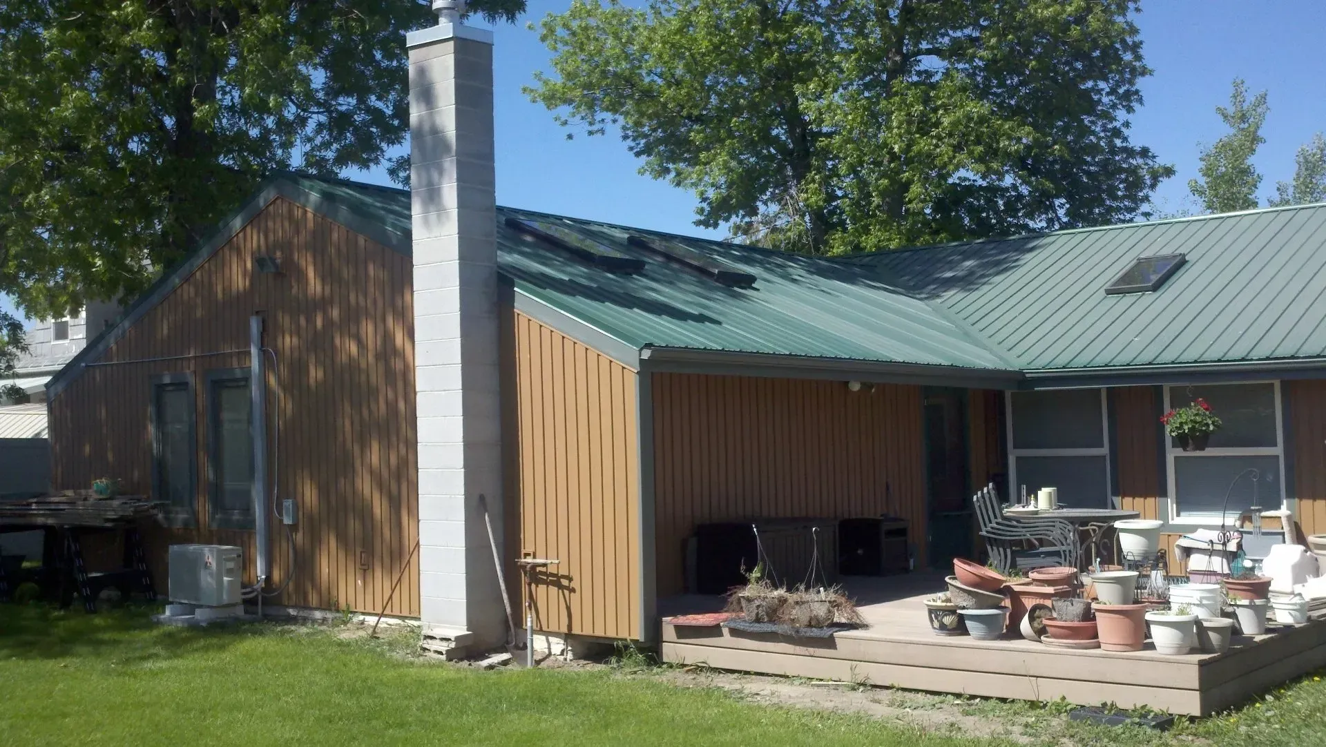 A house with a green roof and a chimney