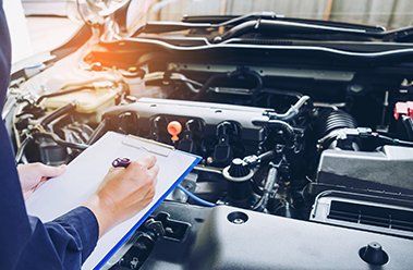 Automatic Transmission Service — Technician Checking the Front Engine in Houston, TX Automatic Transmission Service — Technician Checking the Front Engine in Houston, TX