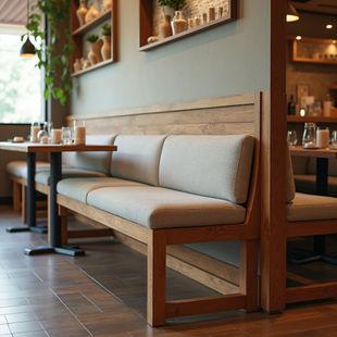 Restaurant booth with wooden frame, upholstered seats, table, and surrounding décor.