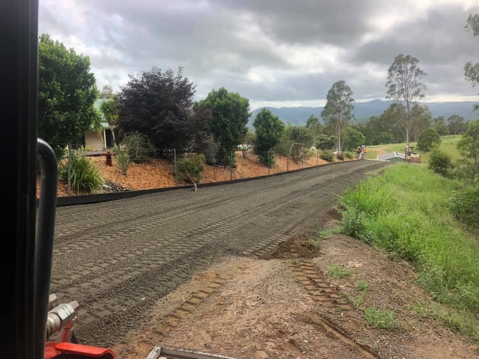 Dirt Road Construction Near a House With Trees and Cloudy Sky — A2Z Property Services In Cooroy, QLD