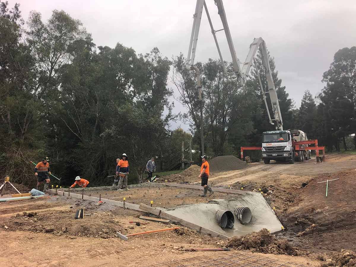 A Group of Construction Workers Are Working on a Road — A2Z Property Services In Kybong, QLD