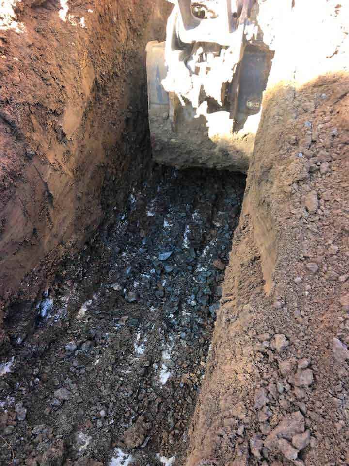 A Bulldozer Is Digging A Hole In The Dirt — A2Z Property Services In Chatsworth, QLD