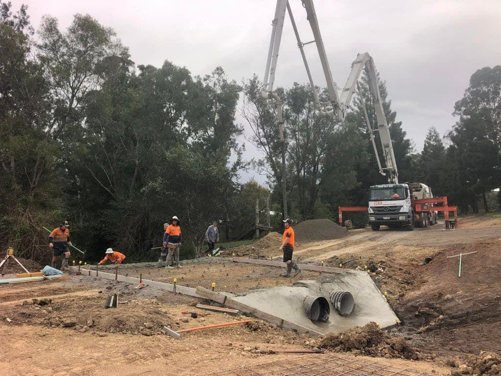 Construction Workers Pouring Concrete at a Bridge Site — A2Z Property Services In Cooroy, QLD